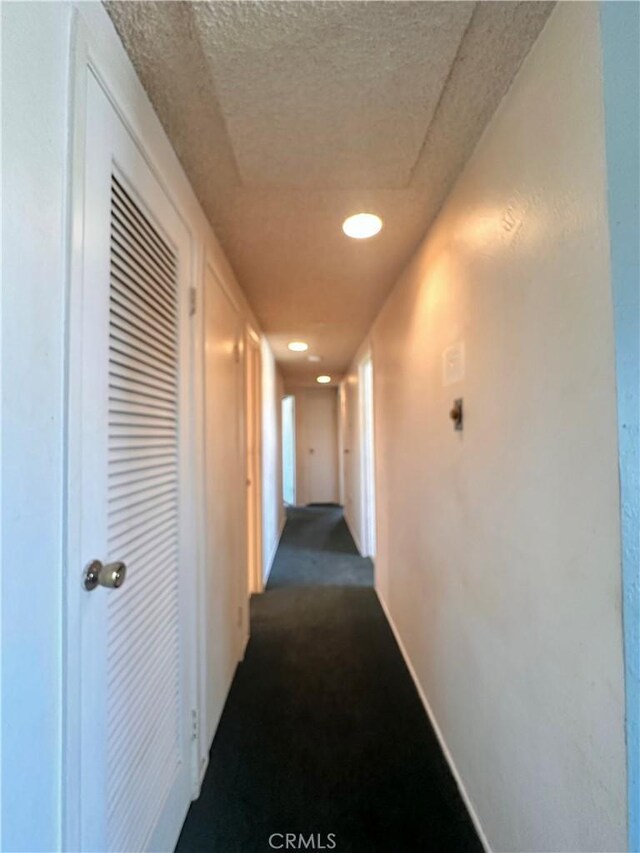 19863 Drasin Dr, Canyon Country, CA 91351 - hall with baseboards and dark carpet