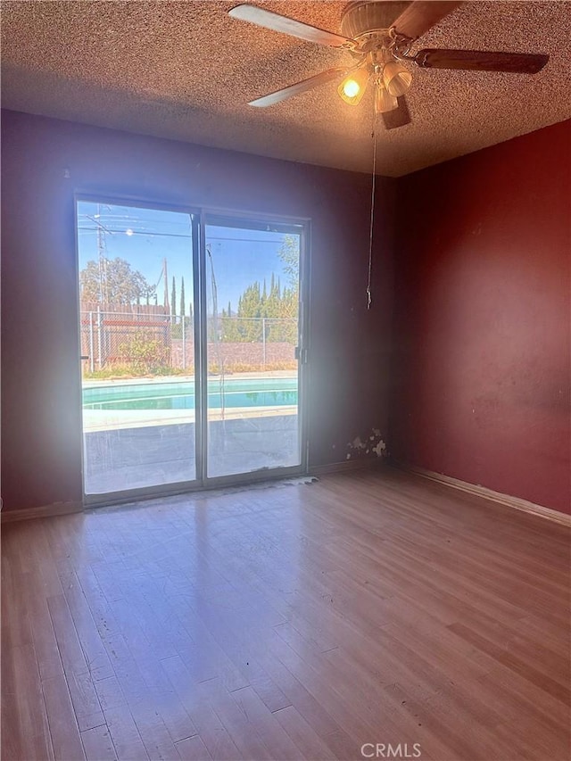 19863 Drasin Dr, Canyon Country, CA 91351 - spare room with a textured ceiling, baseboards, and wood finished floors