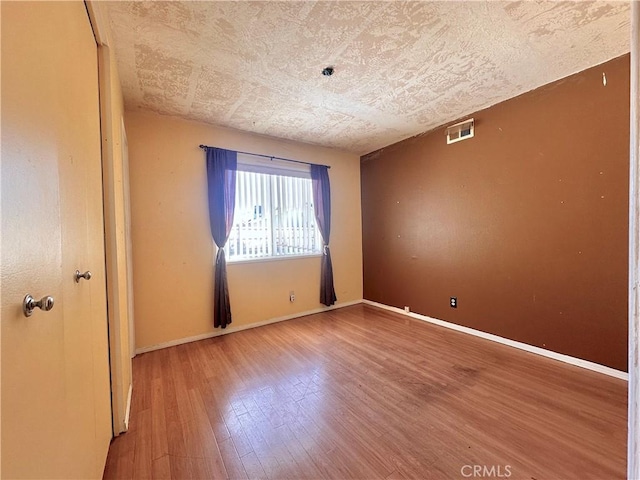 19863 Drasin Dr, Canyon Country, CA 91351 - unfurnished room featuring baseboards, visible vents, and wood finished floors