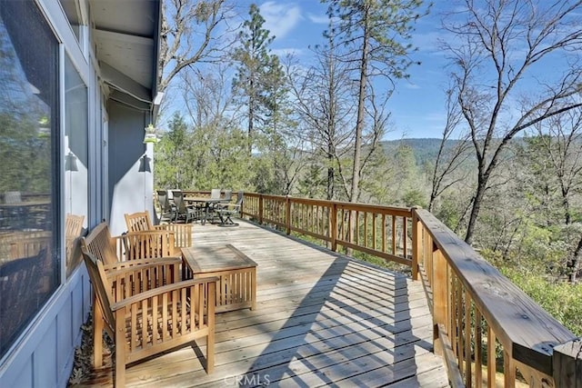wooden terrace featuring outdoor dining area