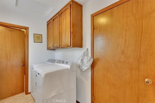 laundry room with independent washer and dryer, cabinet space, and attic access