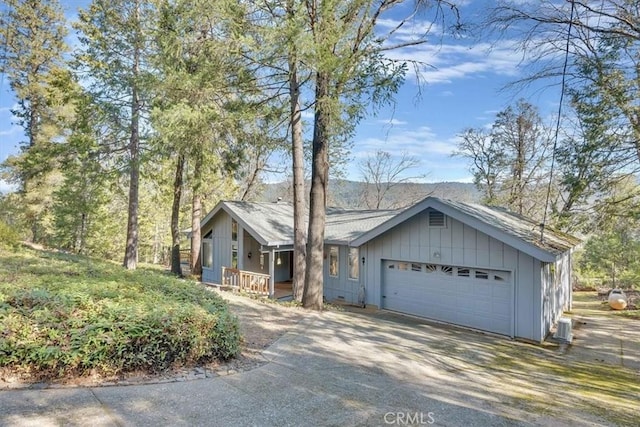 view of front of house featuring board and batten siding, driveway, and an attached garage