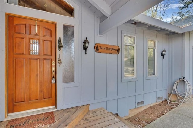 property entrance featuring crawl space and board and batten siding
