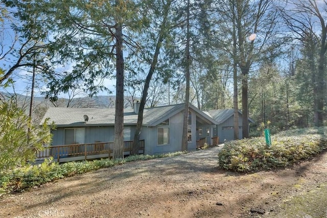 exterior space featuring an attached garage and dirt driveway
