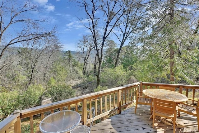 wooden terrace with outdoor dining space