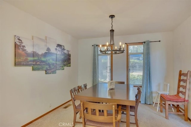 carpeted dining space featuring visible vents, a notable chandelier, and baseboards