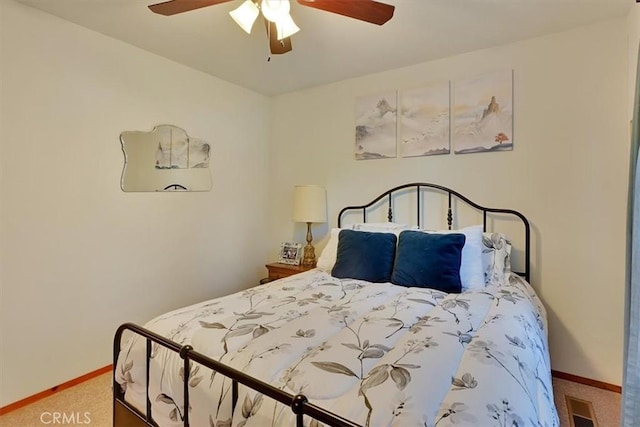 bedroom featuring ceiling fan, carpet floors, visible vents, and baseboards