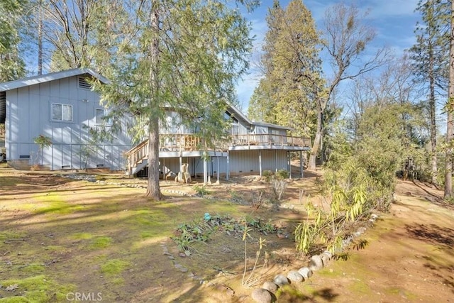 rear view of property featuring a deck