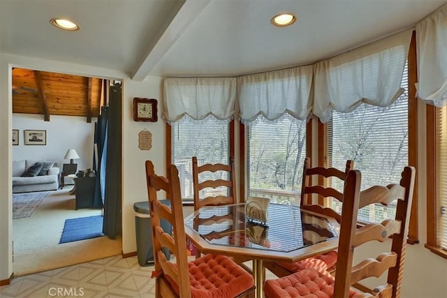 dining space featuring light floors, beam ceiling, and recessed lighting