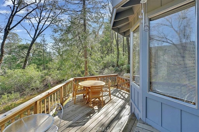 wooden terrace featuring outdoor dining space