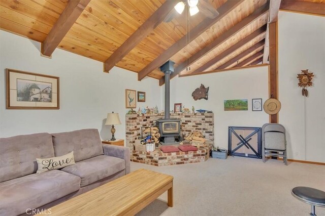 living room featuring carpet floors, vaulted ceiling with beams, a ceiling fan, wood ceiling, and a wood stove
