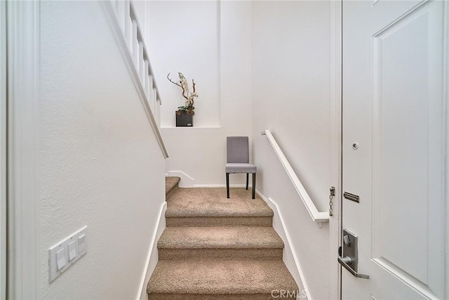 stairway with carpet and baseboards