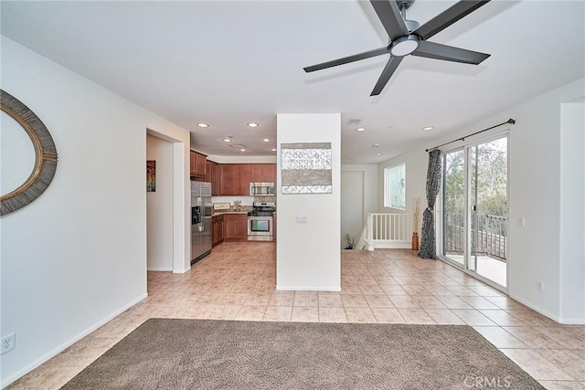 unfurnished living room featuring a ceiling fan, recessed lighting, baseboards, and light tile patterned floors