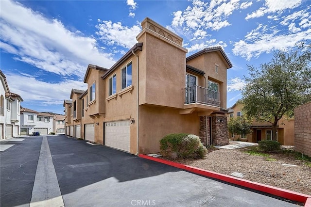 view of side of property featuring a residential view and stucco siding