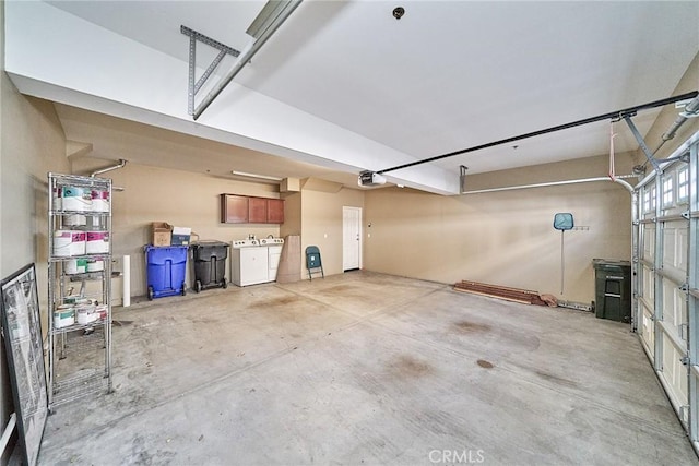 garage featuring a garage door opener and washer and clothes dryer