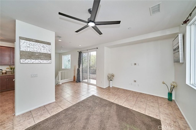 empty room with light tile patterned floors, recessed lighting, visible vents, ceiling fan, and baseboards