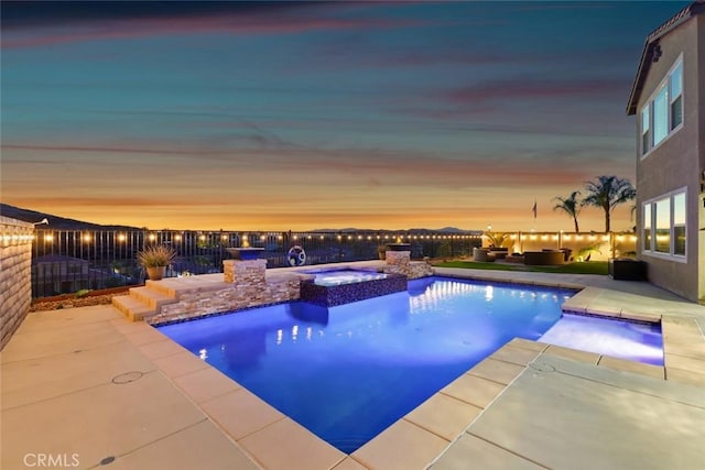 view of pool featuring a pool with connected hot tub, a fenced backyard, and a patio