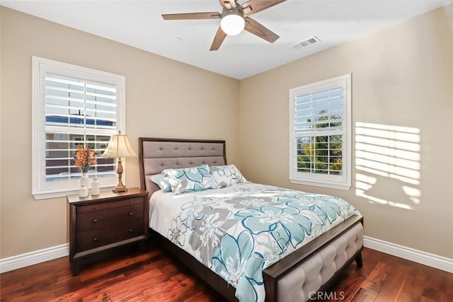 bedroom featuring visible vents, ceiling fan, baseboards, and wood finished floors