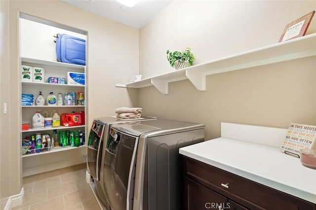 washroom with laundry area, light tile patterned floors, baseboards, and independent washer and dryer