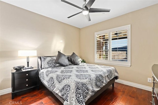 bedroom with ceiling fan, wood finished floors, and baseboards