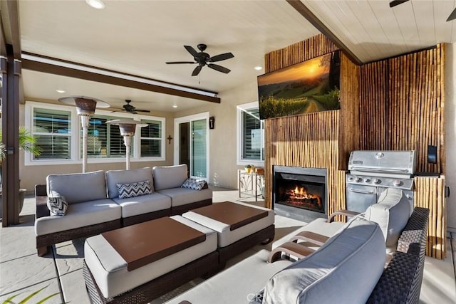 view of patio with an outdoor living space with a fireplace, a grill, and ceiling fan