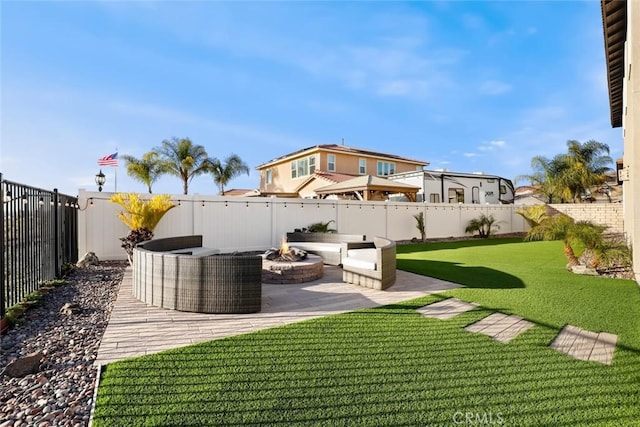 view of yard featuring a fire pit, a patio area, and a fenced backyard