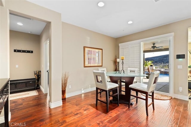 dining area featuring recessed lighting, baseboards, and wood finished floors