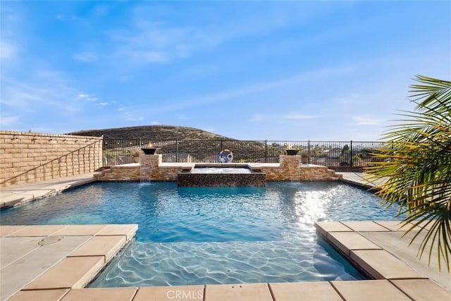 view of swimming pool with fence, a fenced in pool, and an in ground hot tub