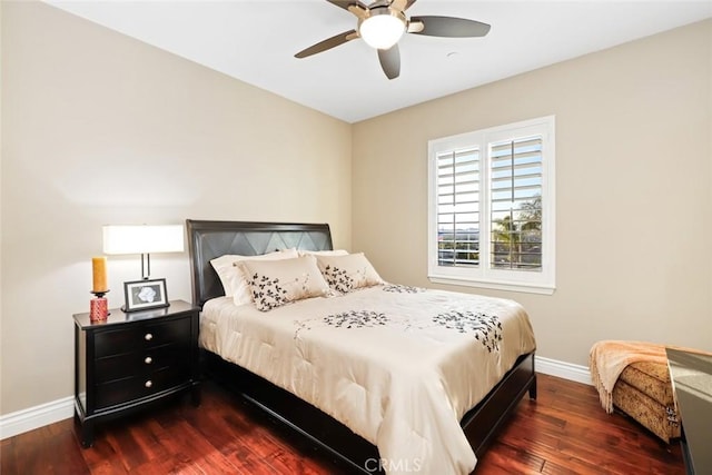 bedroom with dark wood-type flooring, ceiling fan, and baseboards