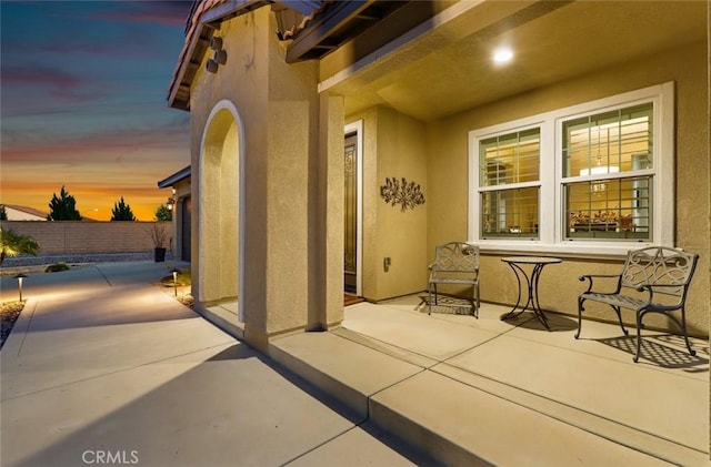 view of patio / terrace featuring fence