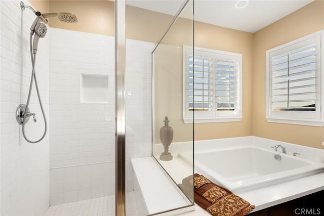 full bathroom with a stall shower and a garden tub