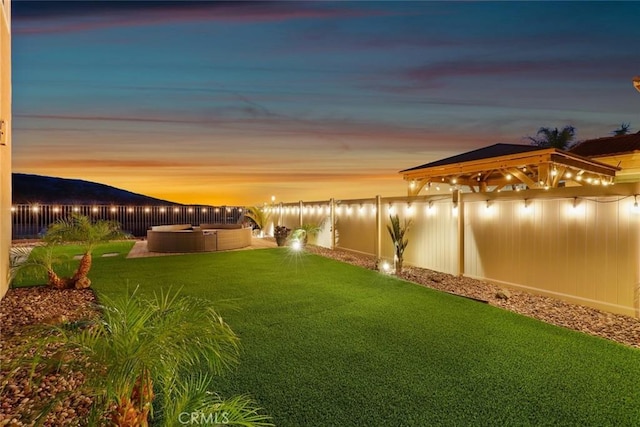 view of yard featuring a fenced backyard and a hot tub