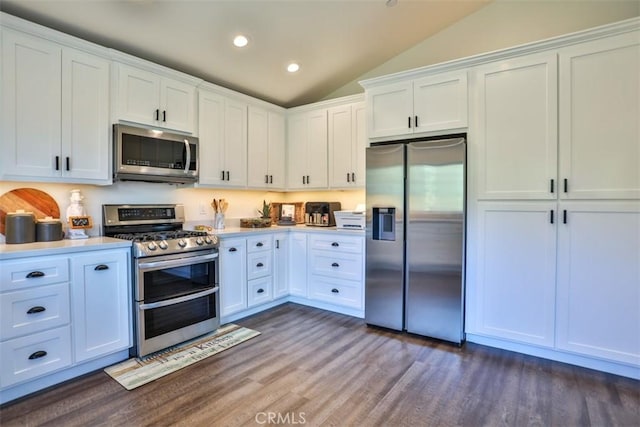 28622 Shenandoah Dr, Lake Arrowhead, CA 92352 - kitchen featuring stainless steel appliances, vaulted ceiling, dark wood-style flooring, white cabinetry, and light countertops