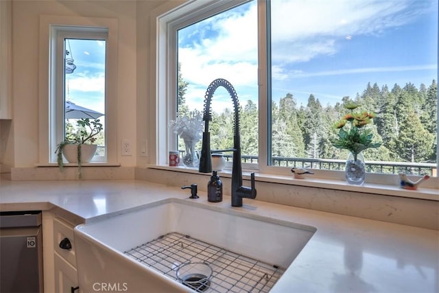 28622 Shenandoah Dr, Lake Arrowhead, CA 92352 - kitchen view of a sink, white cabinets, light countertops, and dishwasher