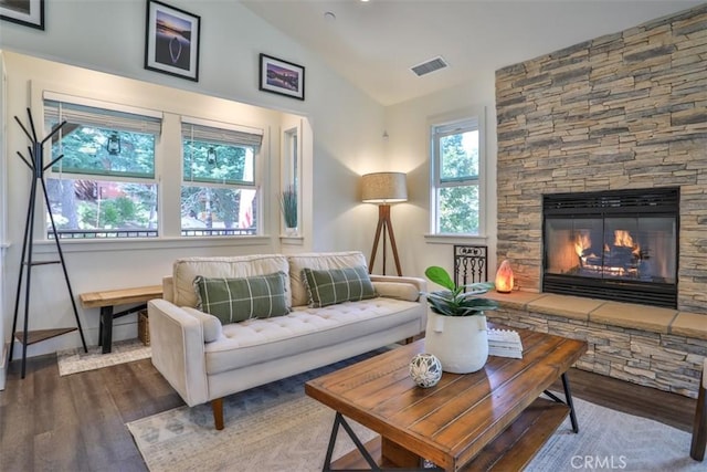 28622 Shenandoah Dr, Lake Arrowhead, CA 92352 - living room featuring dark wood-style flooring, vaulted ceiling, and a stone fireplace