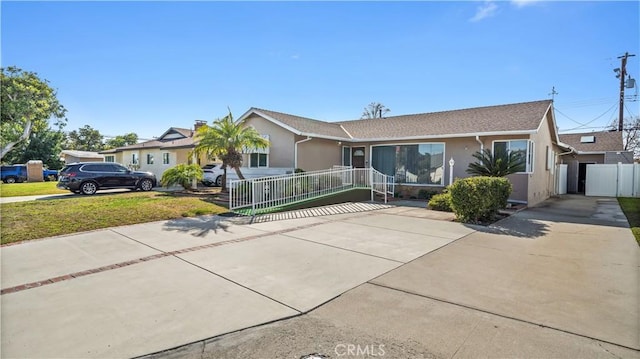 single story home featuring fence, driveway, a front lawn, and stucco siding