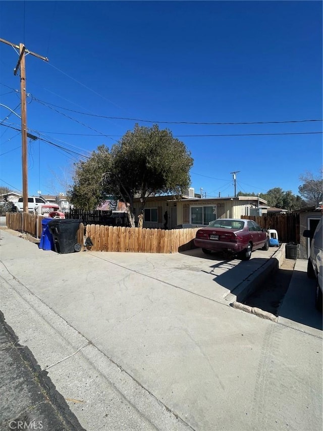 ranch-style home featuring fence