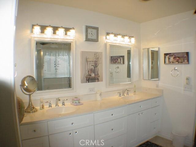 bathroom with double vanity and a sink