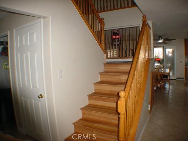 stairs with a ceiling fan