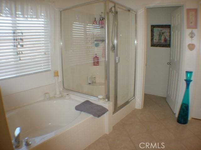 full bathroom featuring a shower stall and a bath