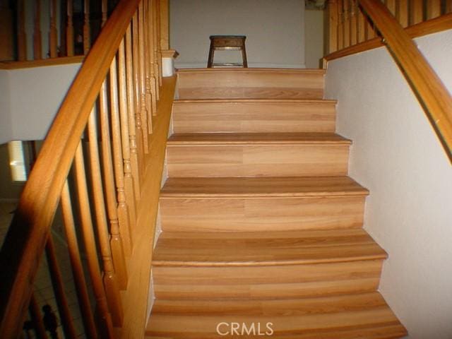 staircase featuring wood finished floors