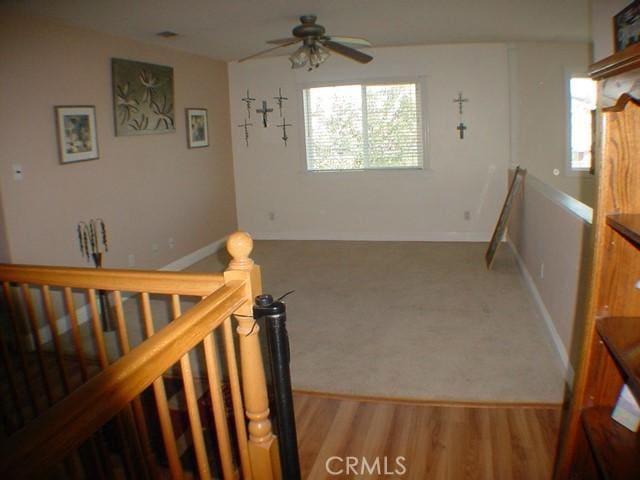 interior space featuring ceiling fan and wood finished floors