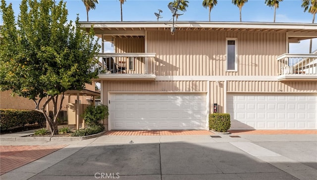 view of property featuring a balcony and an attached garage