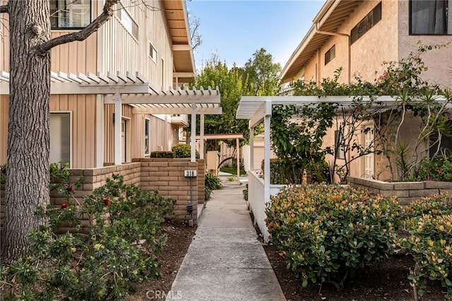 view of community featuring fence and a pergola