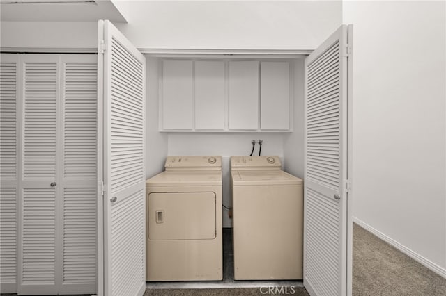 laundry area featuring baseboards, cabinet space, carpet, and washing machine and clothes dryer