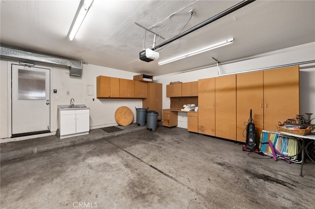 garage with a garage door opener and a sink