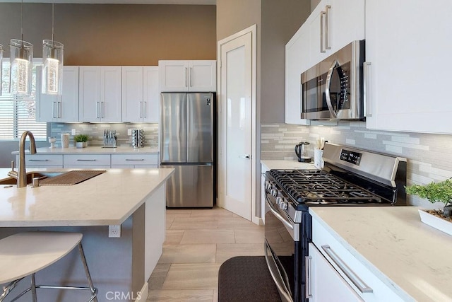 kitchen featuring white cabinets, stainless steel appliances, and a sink