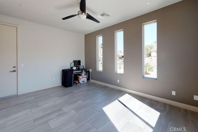 unfurnished office featuring baseboards, visible vents, and ceiling fan