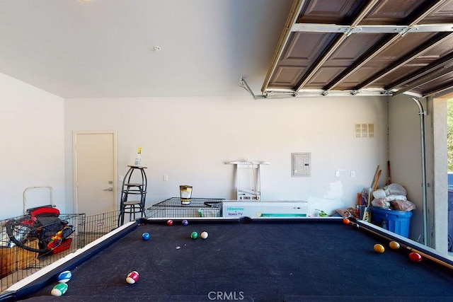 garage featuring electric panel and visible vents