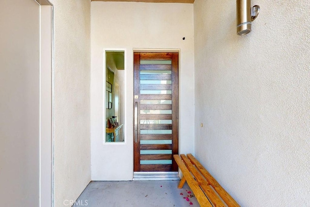 doorway to property with stucco siding